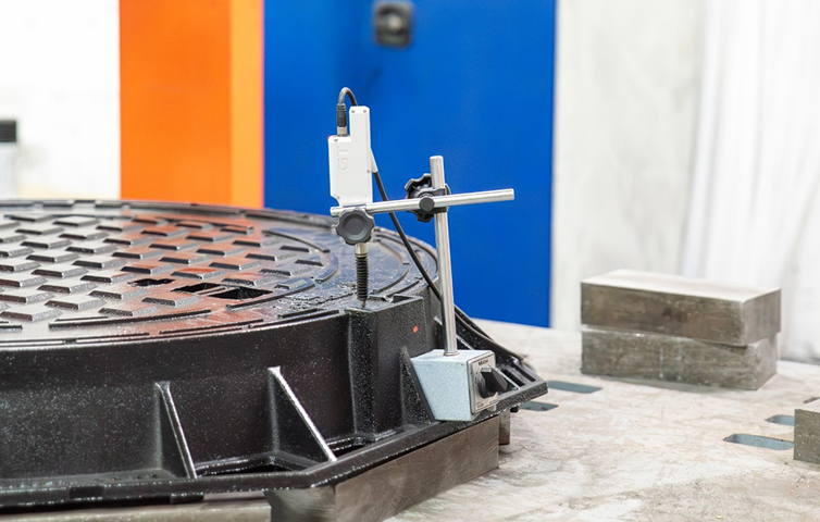 Digital measuring equipment installed on a manhole cover in a laboratory environment